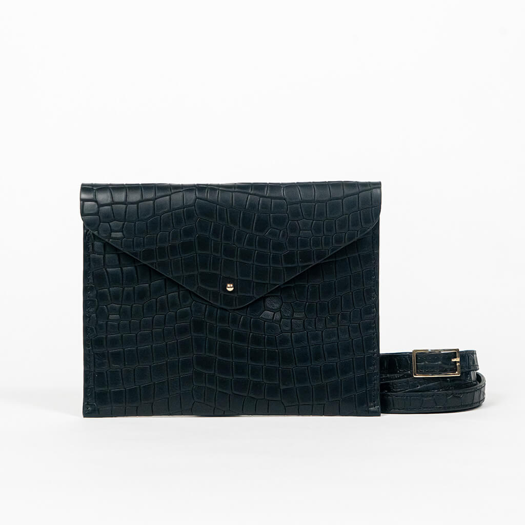 Black leather clutch bag with a strap on a white background
