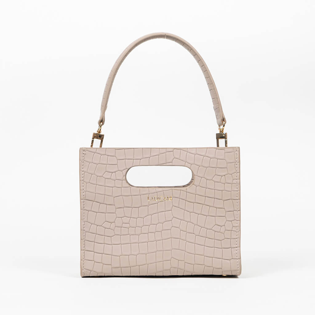 Beige textured cassette bag with a visible brand logo and strap on a white background