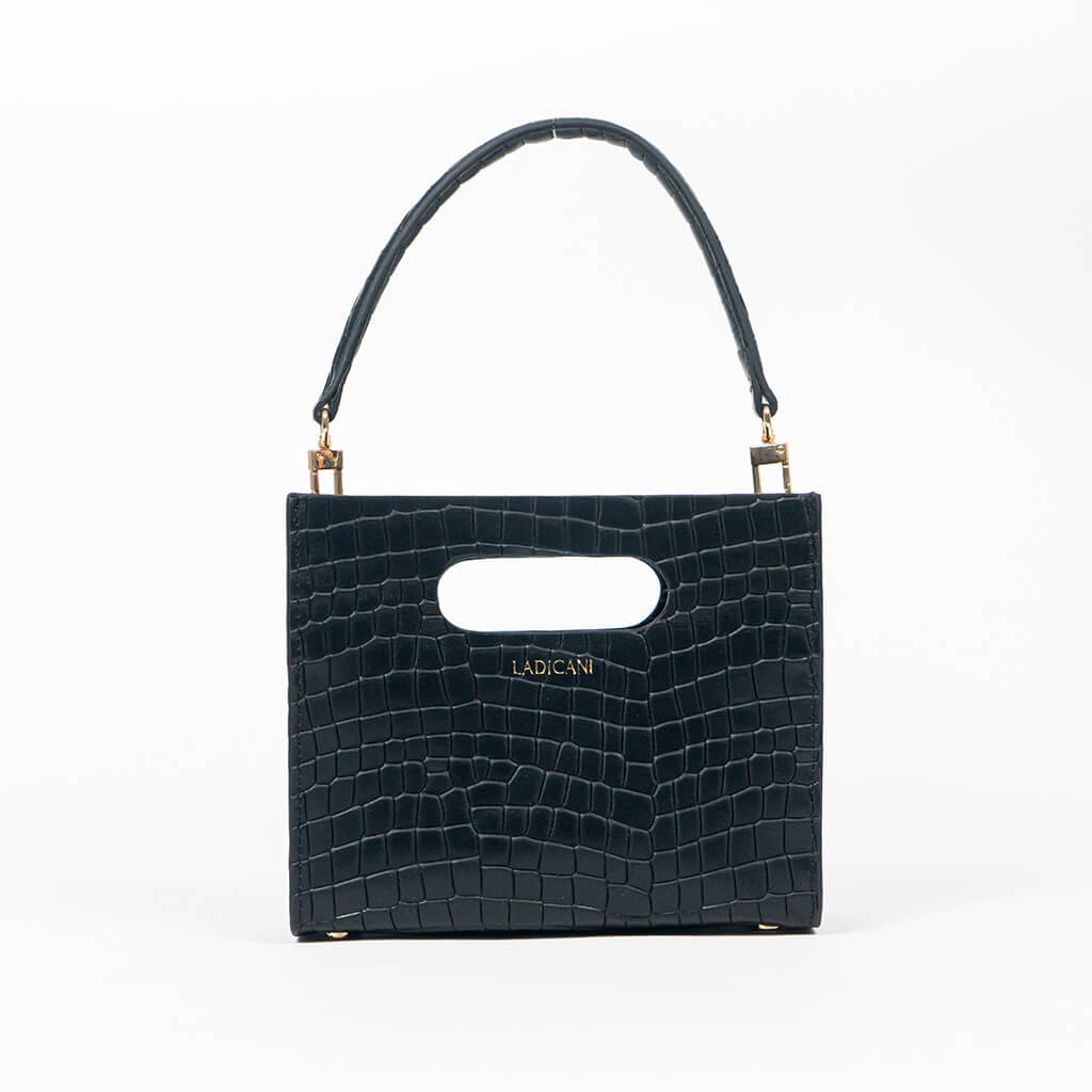 Black textured cassette bag with a visible brand logo and strap on a white background