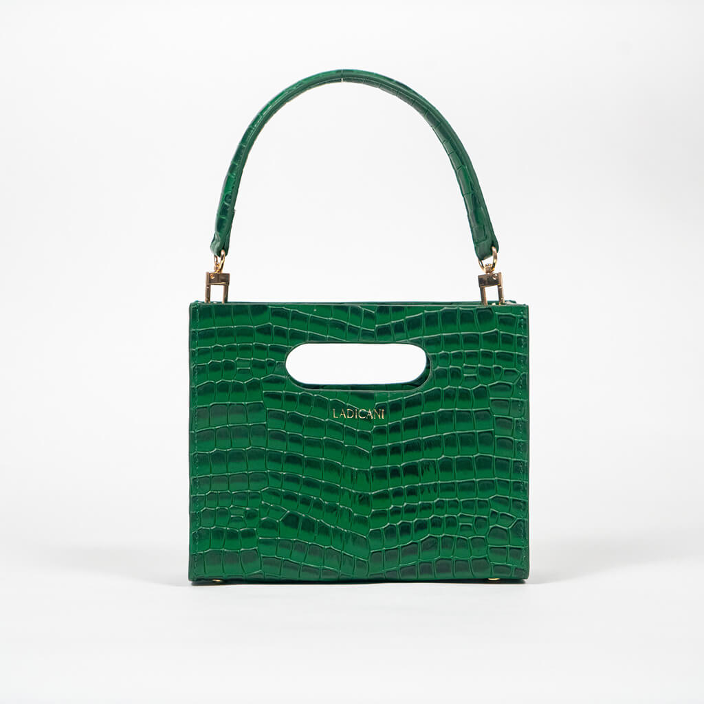 Green textured cassette bag with a visible brand logo and strap on a white background