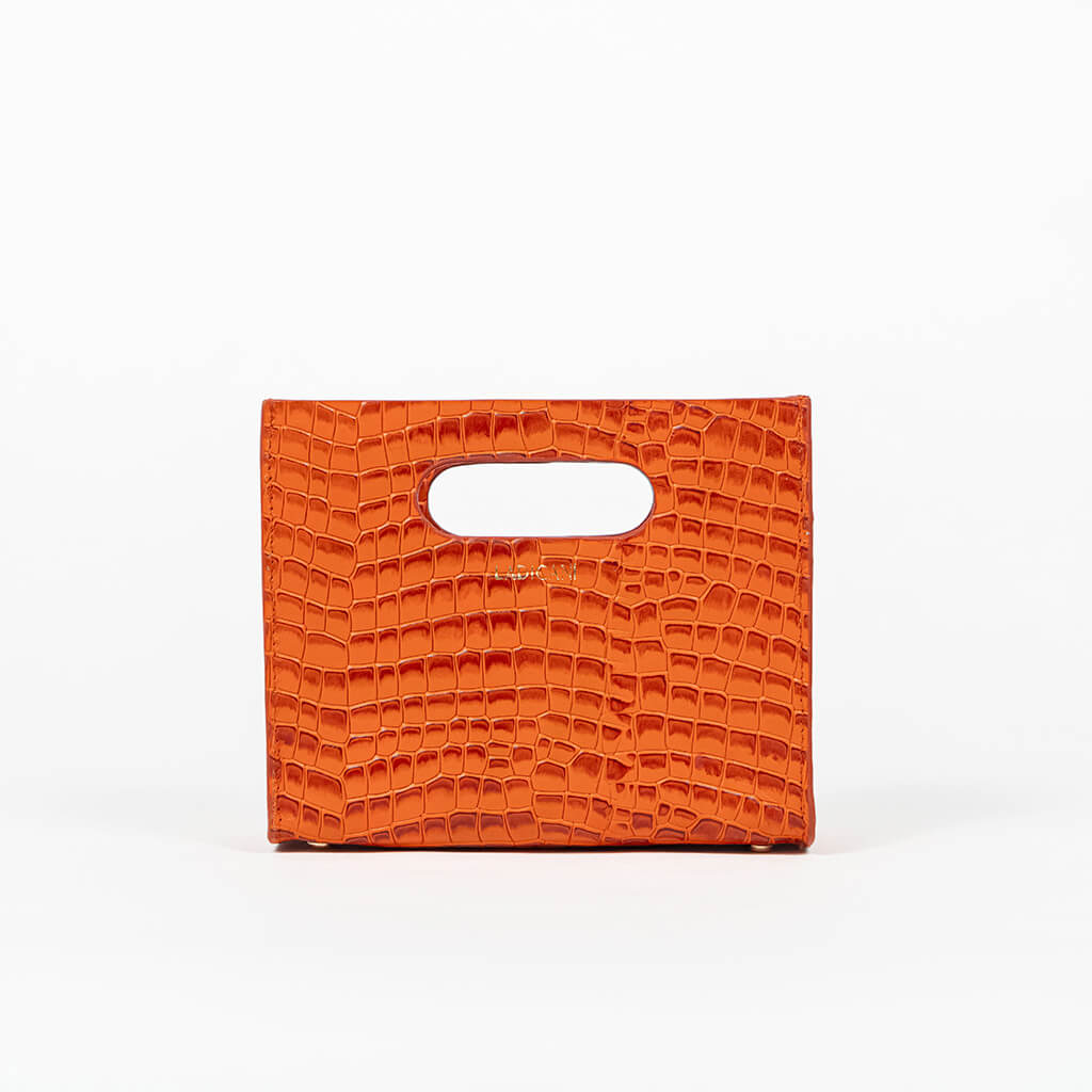 Orange textured cassette bag with a visible brand logo on a white background