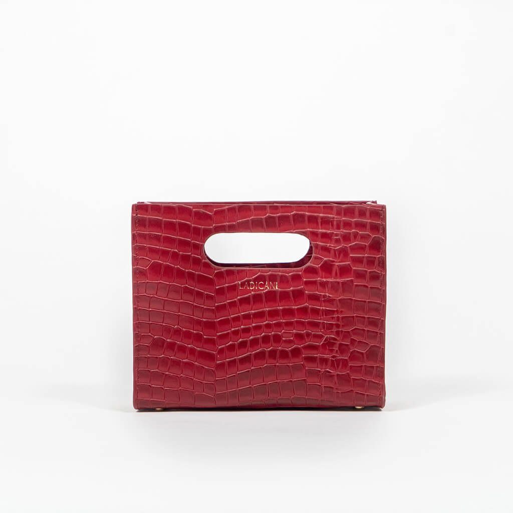 Red textured cassette bag with a visible brand logo on a white background