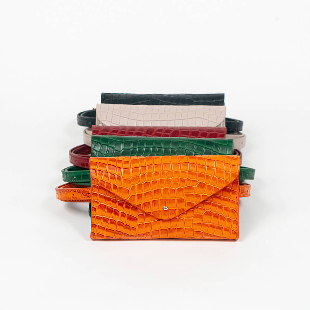 Set of colorful mini clutch bags on a white background, front facing