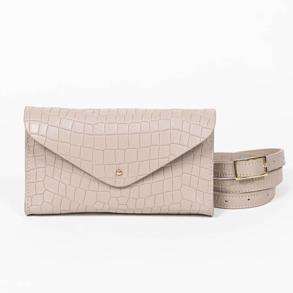 Beige mini clutch bag with matching belt on a white background