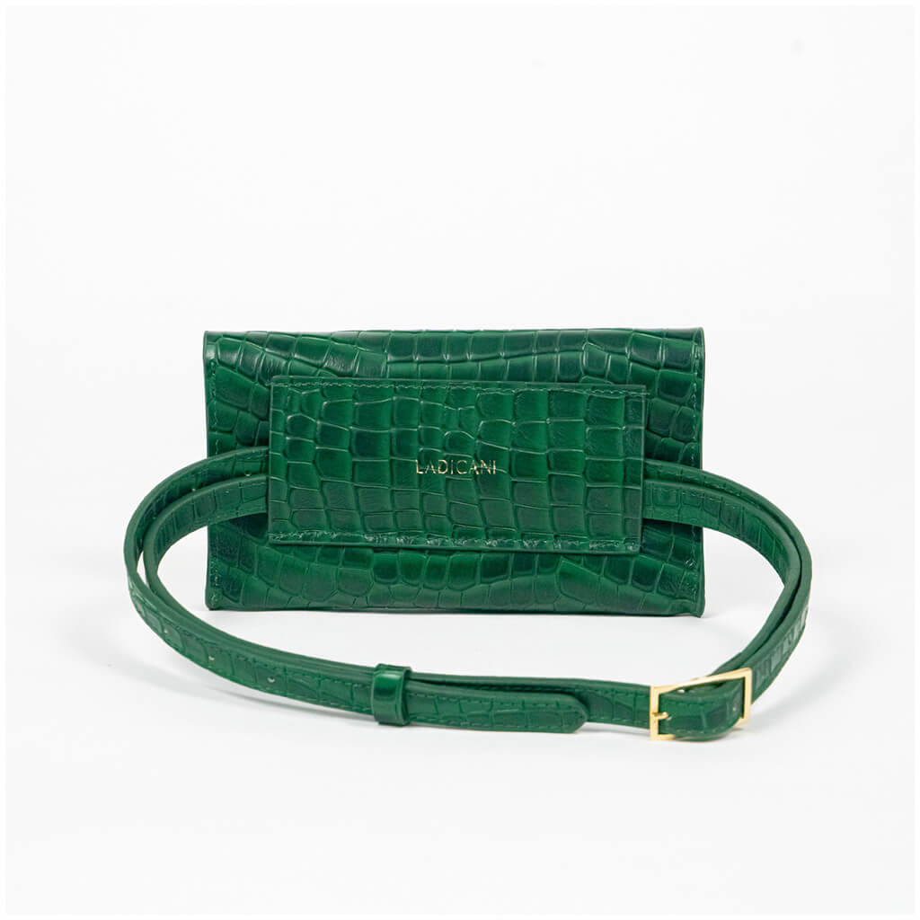 Back of a green mini clutch bag with extended matching belt on a white background
