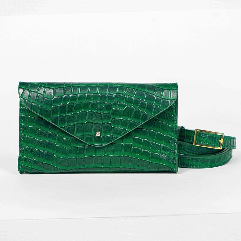 Green mini clutch bag with matching belt on a white background