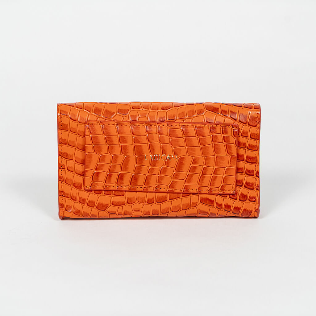Back of an orange mini clutch bag on a white background