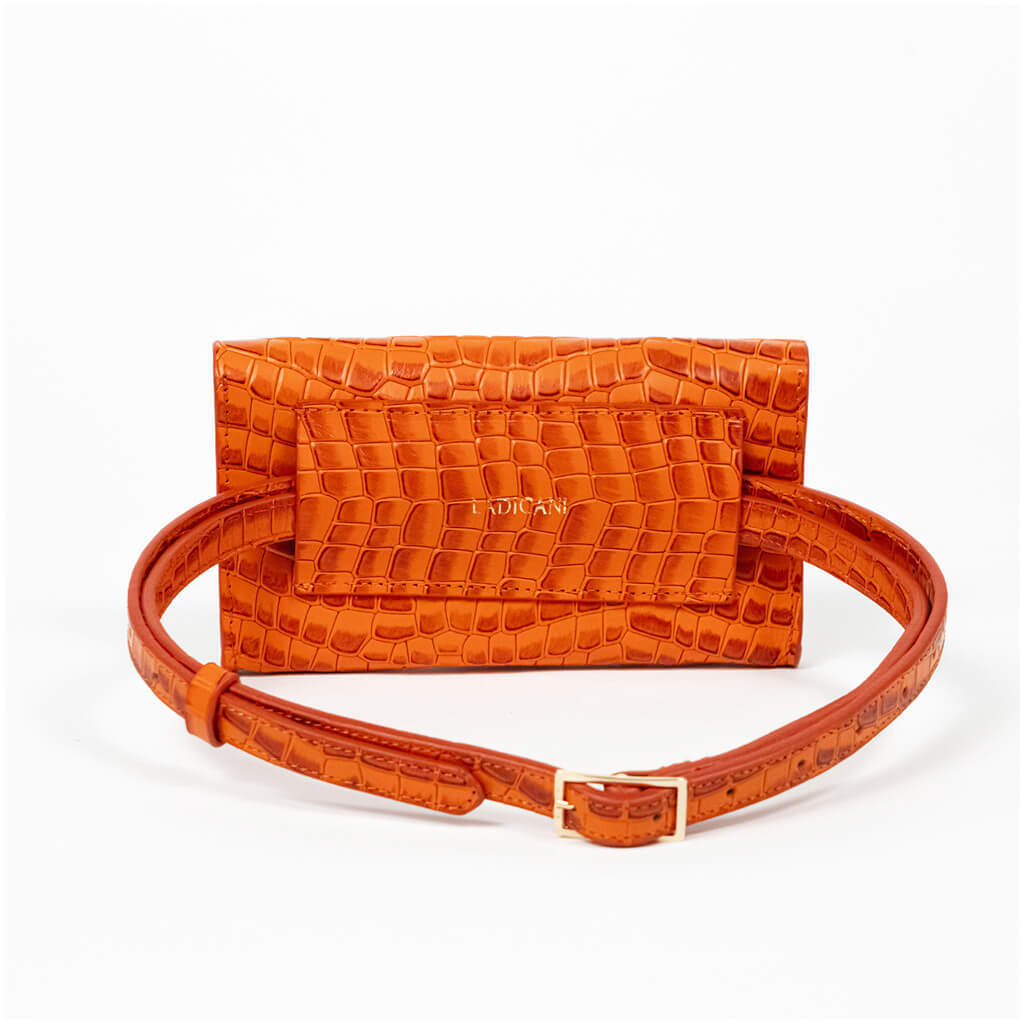 Back of an orange mini clutch bag with matching belt on a white background