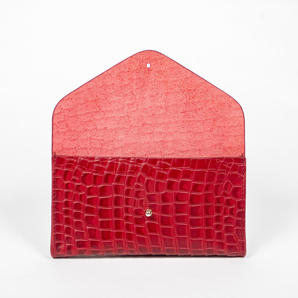 Red mini clutch bag opened on a white background