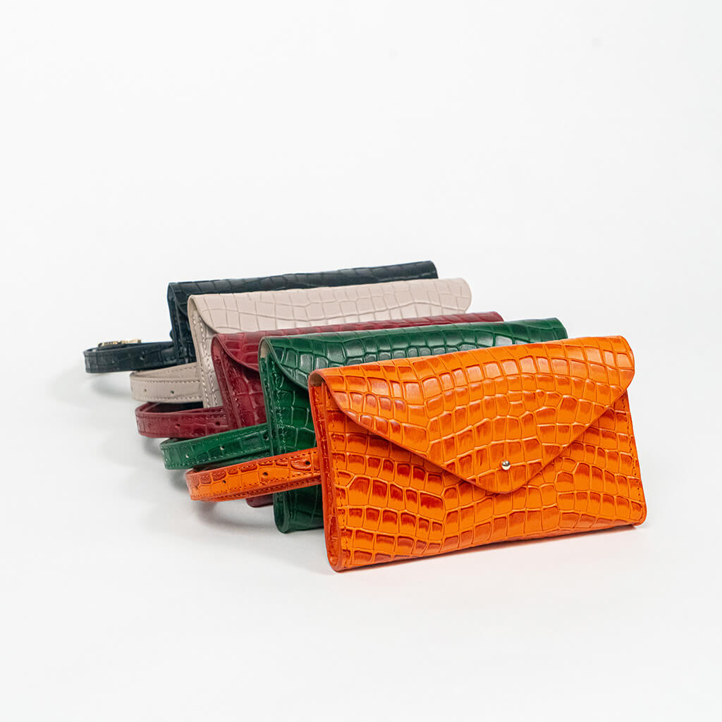 Set of colorful mini clutch bags on a white background