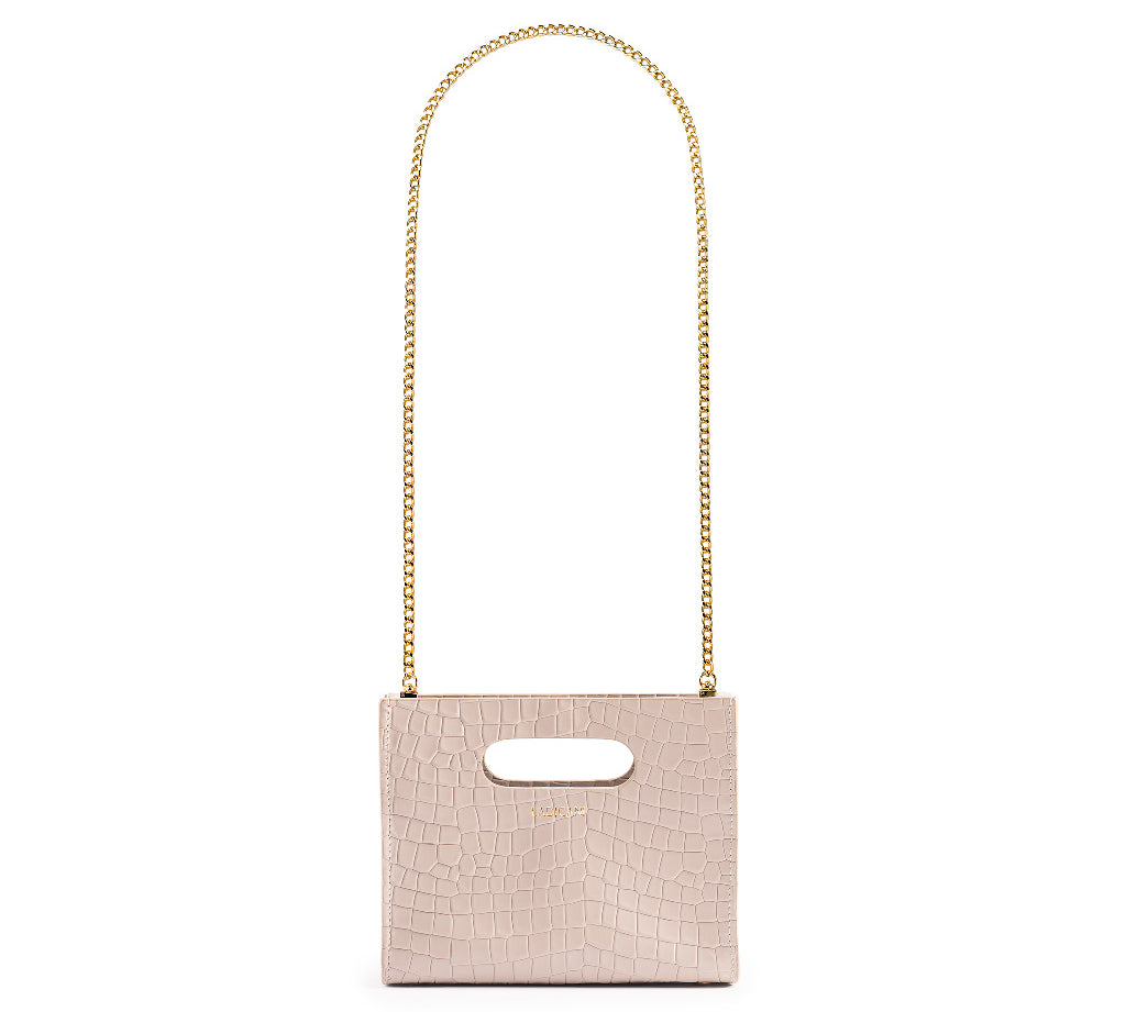 Beige textured cassette bag with a visible brand logo and long gold chain strap on a white background