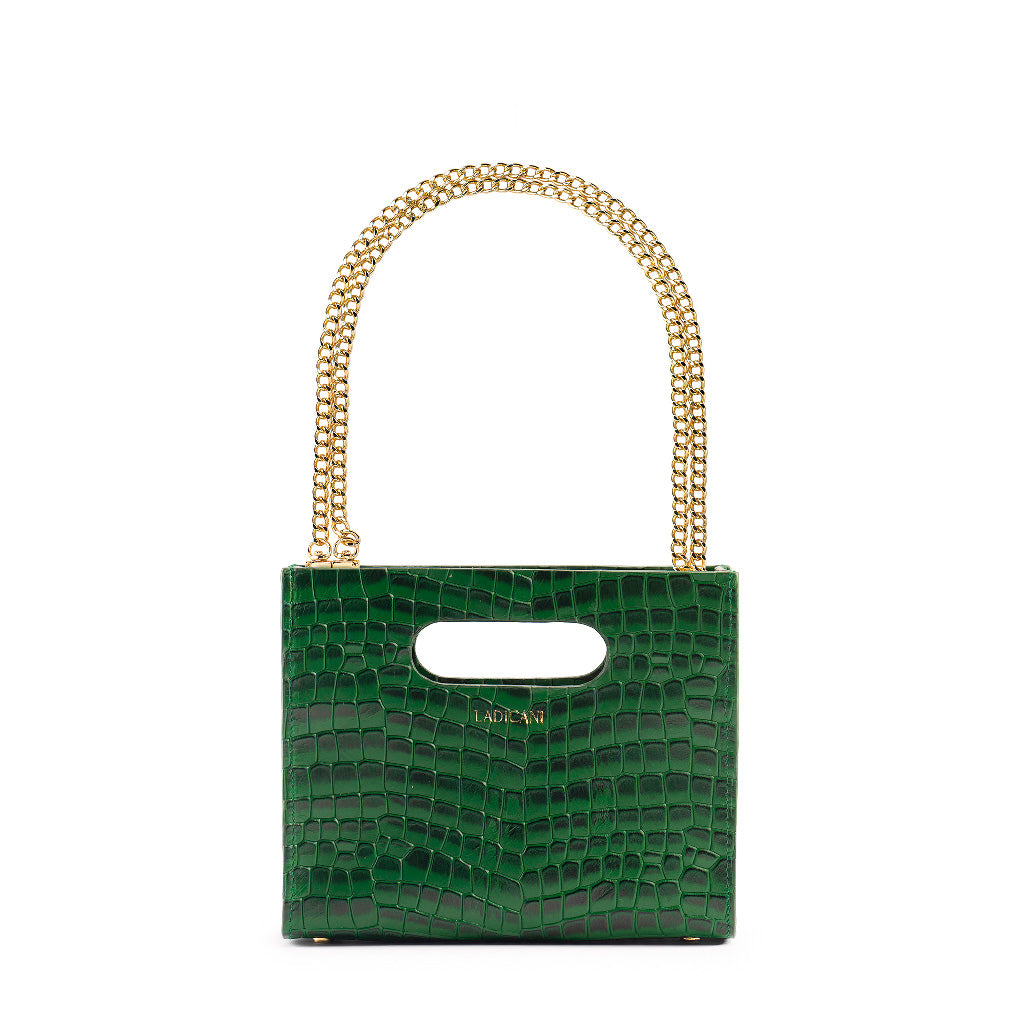 Green textured cassette bag with a visible brand logo and short gold chain strap on a white background