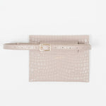 Back of a beige leather clutch bag with a strap on a white background