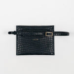 Back of a black leather clutch bag with a strap on a white background