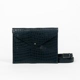 Black leather clutch bag with a strap on a white background