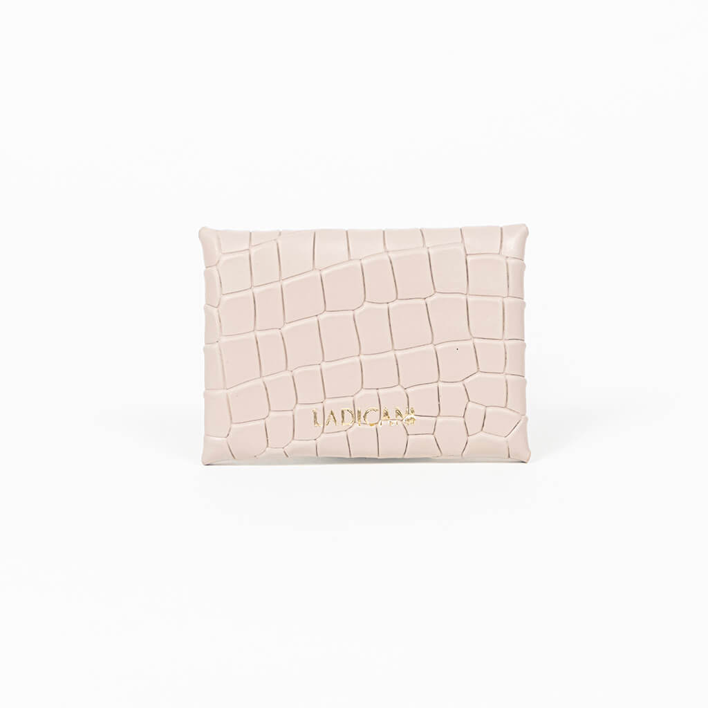 Back of a beige leather cardholder on a white background