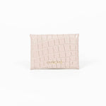 Back of a beige leather cardholder on a white background