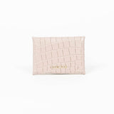 Back of a beige leather cardholder on a white background