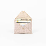 Open beige leather cardholder on a white background