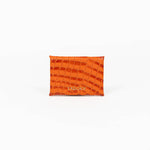 Back of an orange leather cardholder on a white background