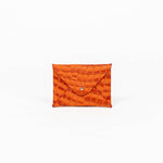 Orange leather cardholder on a white background