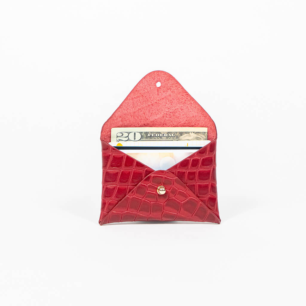 Open red leather cardholder on a white background