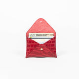 Open red leather cardholder on a white background