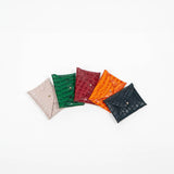 Five leather cardholders in different colors on a white background