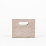 Beige textured cassette bag with a visible brand logo on a white background