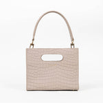 Beige textured cassette bag with a visible brand logo and strap on a white background