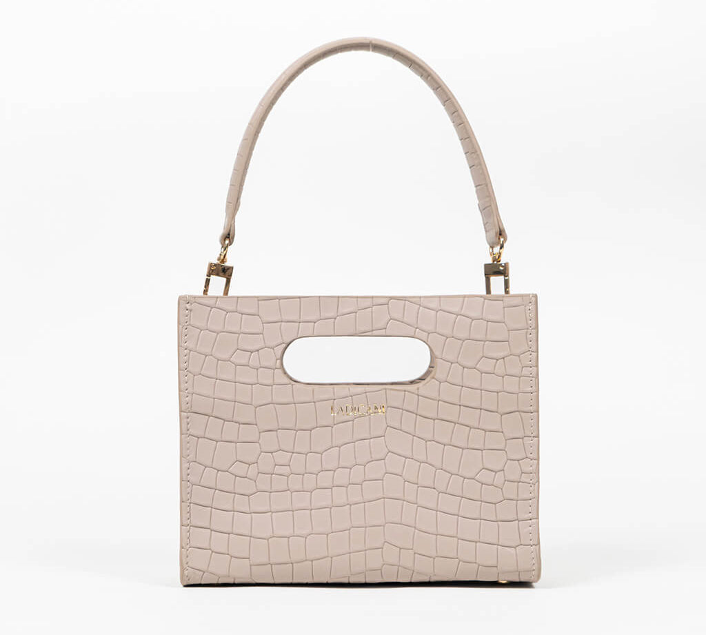 Beige textured cassette bag with a visible brand logo and strap on a white background
