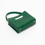 Beige textured cassette bag with a visible brand logo and strap layng down on a white background