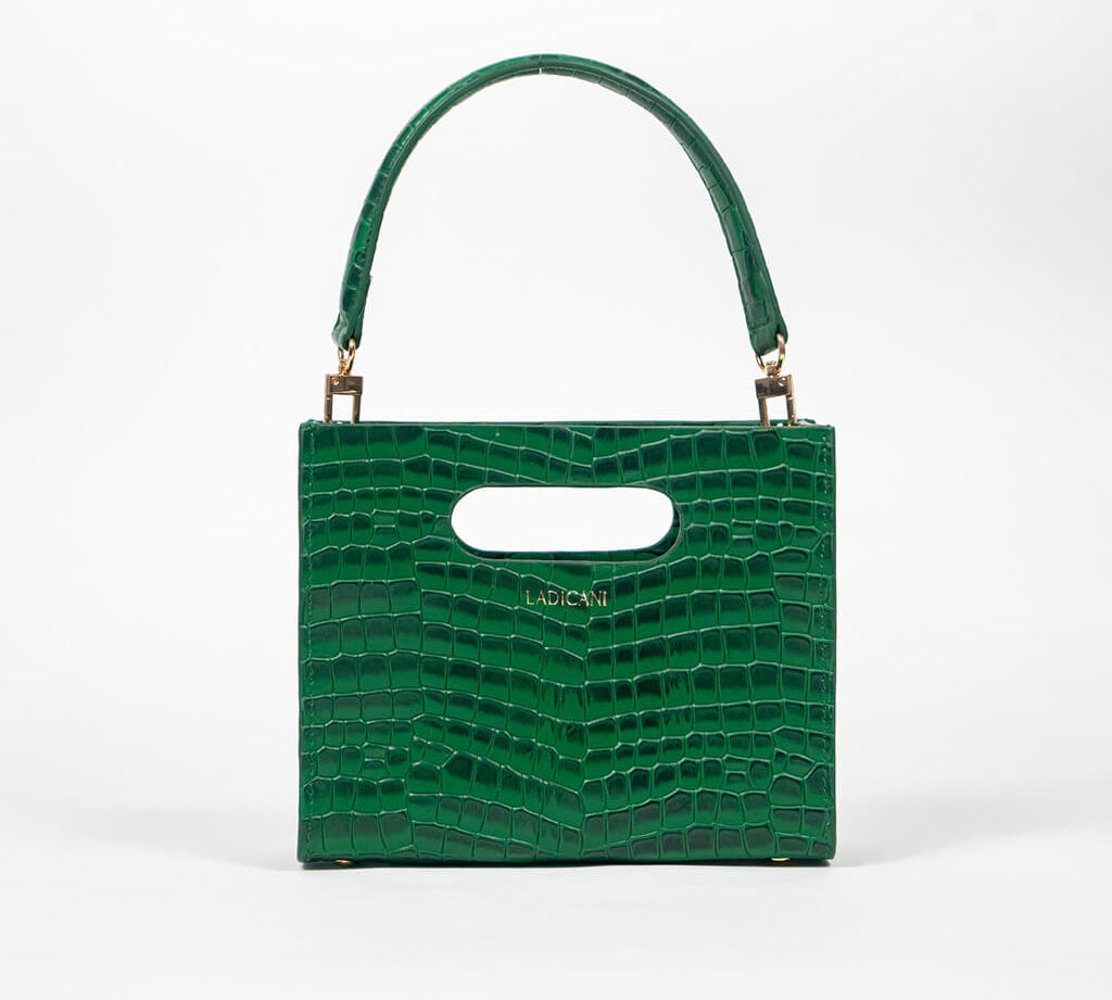 Green textured cassette bag with a visible brand logo and strap on a white background