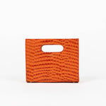 Orange textured cassette bag with a visible brand logo on a white background