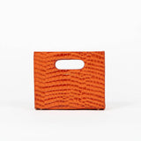 Orange textured cassette bag with a visible brand logo on a white background