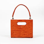 Orange textured cassette bag with a visible brand logo and strap on a white background
