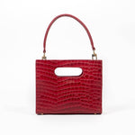 Red textured cassette bag with a visible brand logo and strap on a white background