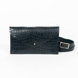 Black mini clutch bag with matching belt on a white background