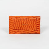 Back of an orange mini clutch bag on a white background