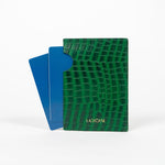 Back of a green leather passport holder with a blue passport on a white background