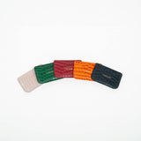 Colorful leather slim wallets arranged on an arc with branding on a white background