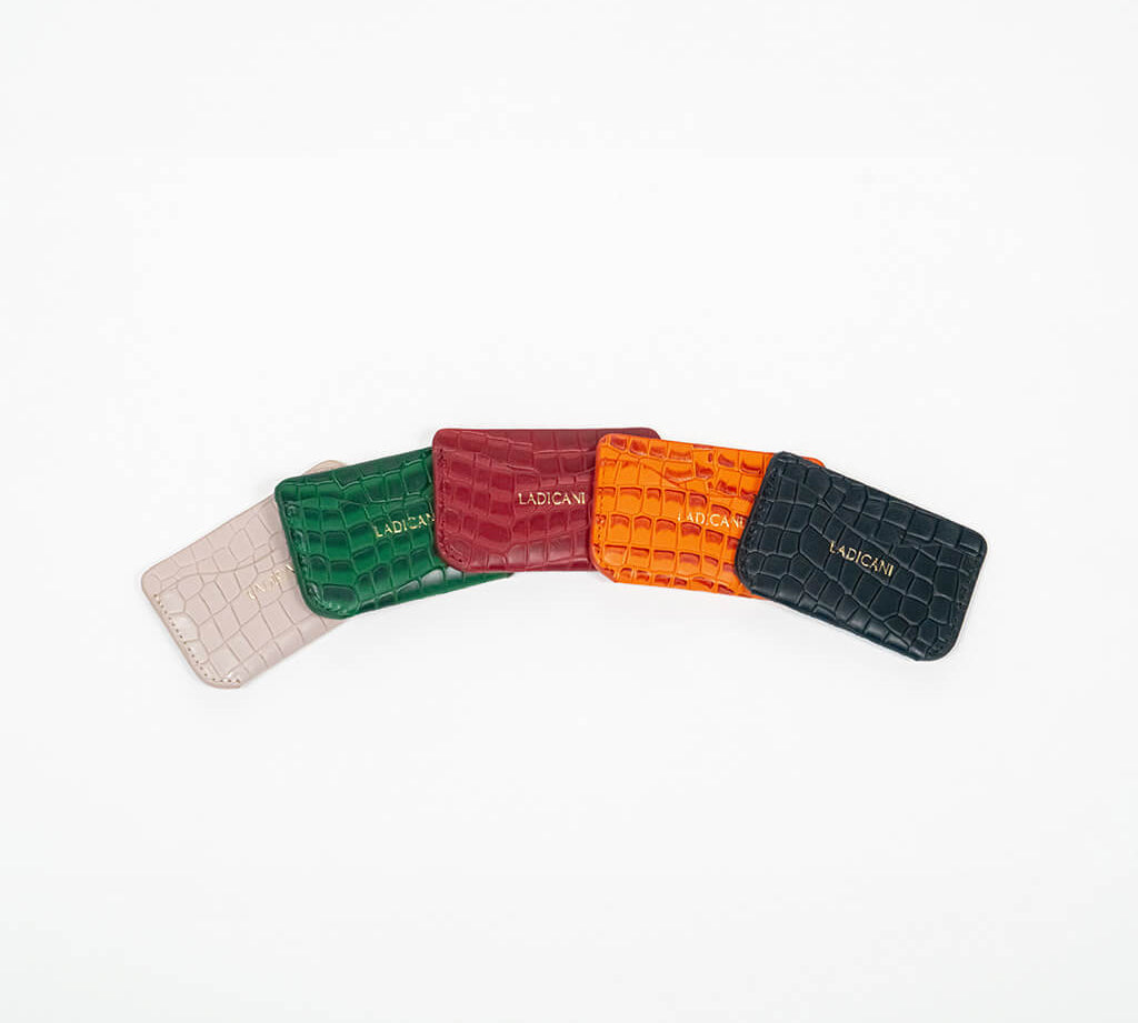 Colorful leather slim wallets arranged on an arc with branding on a white background