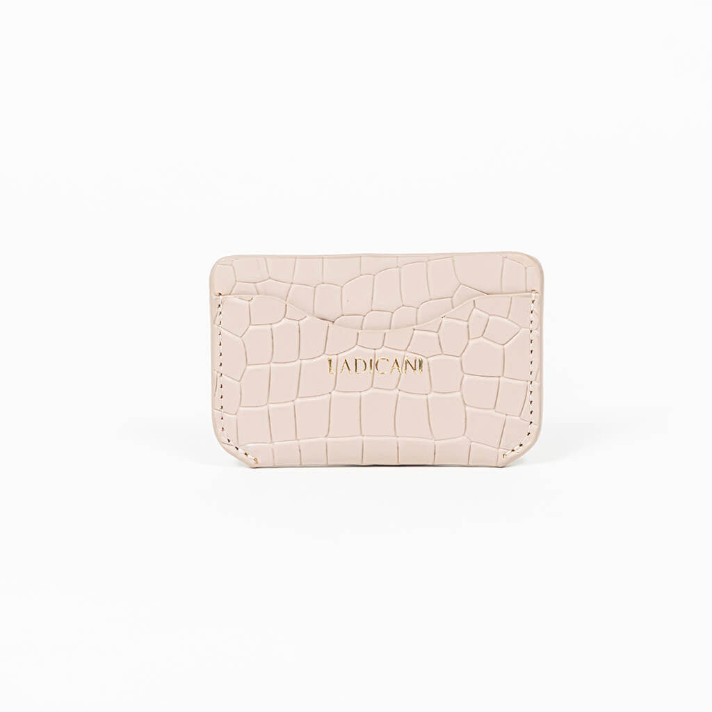 Beige leather slim wallet with branding on a white background