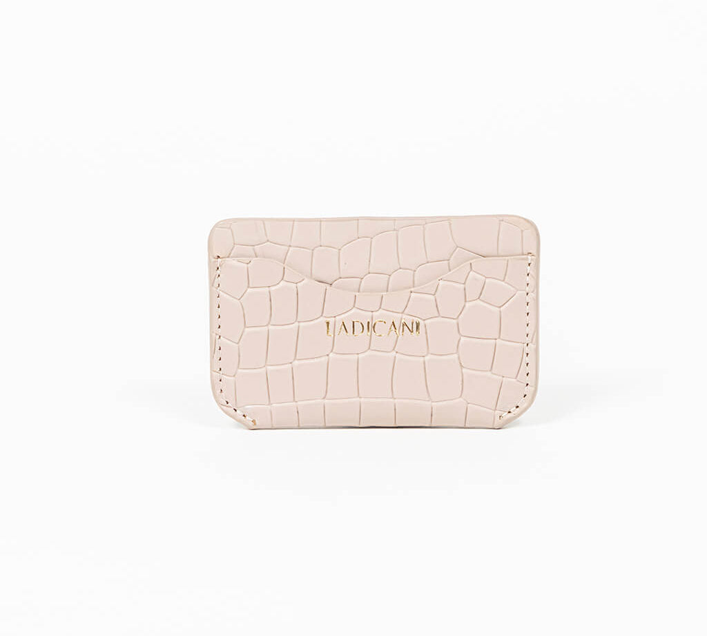 Beige leather slim wallet with branding on a white background