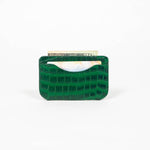 Green leather slim wallet with money and a card on a white background