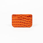 Orange leather slim wallet with branding on a white background