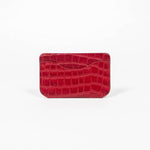 Back of a red leather slim wallet on a white background