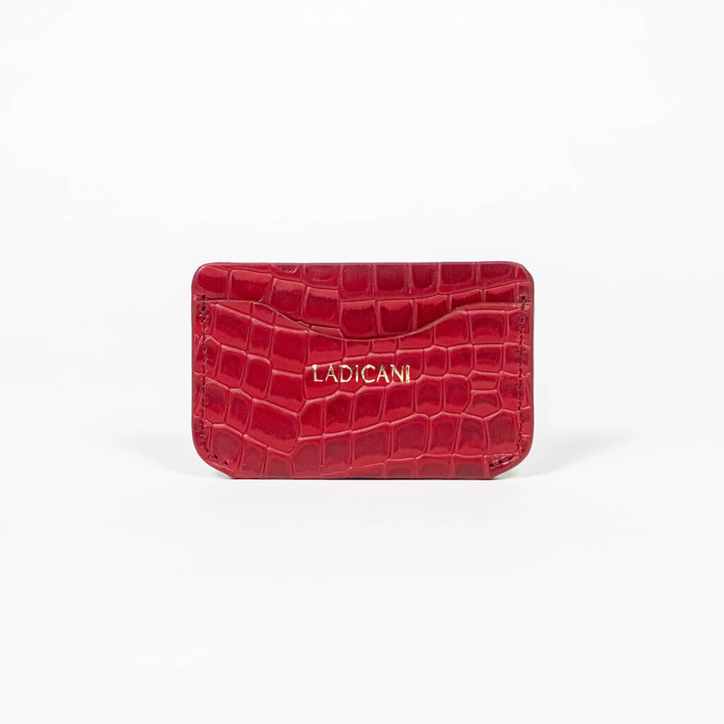 Red leather slim wallet with branding on a white background