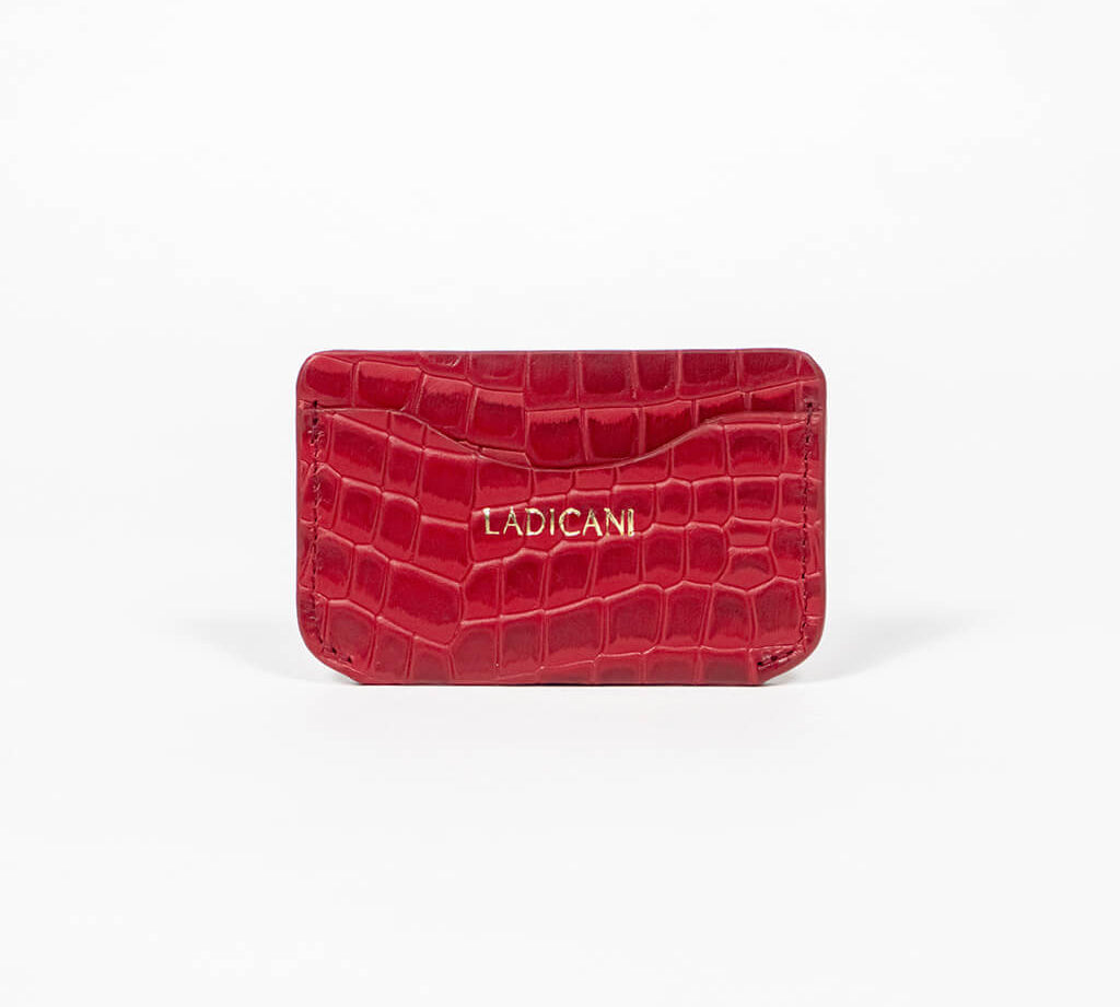 Red leather slim wallet with branding on a white background