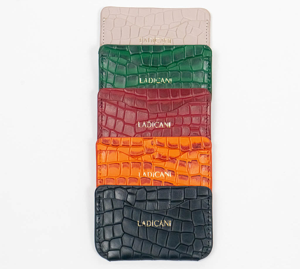 Colorful leather slim wallets with branding on a white background